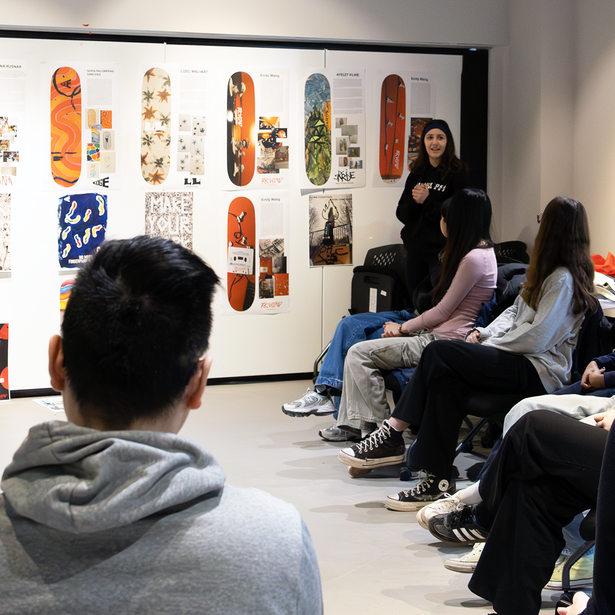 Students looking at work in a graphic design class